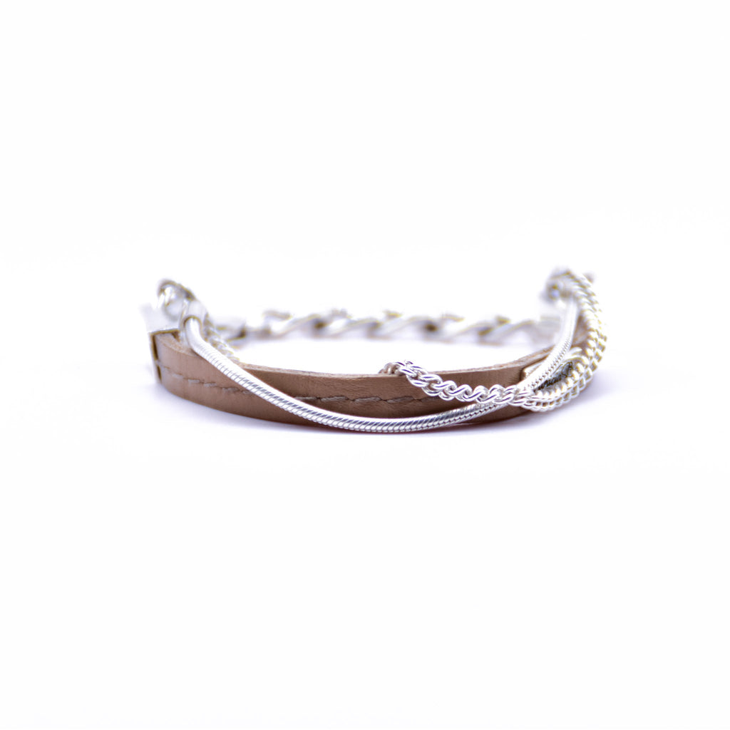 Kika Bracelet by Patricia Bos with three sterling silver chains and a thin saddle-stitched leather band, combining refined craftsmanship with modern design.
